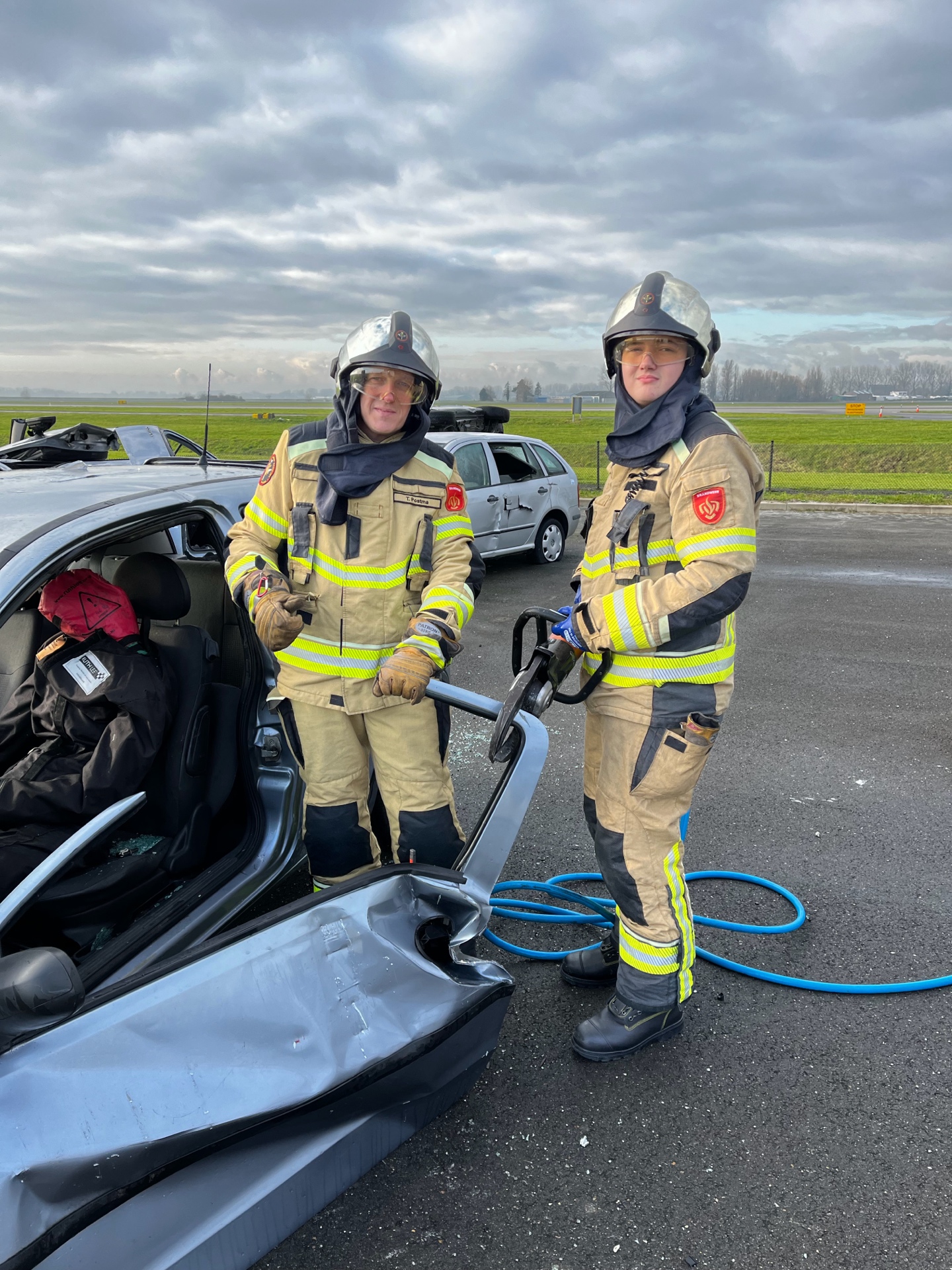 Tom Postma and his son Raimon in full firefighter gear during a training exercise at Schiphol Airport